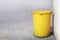 Bin plastic yellow color old for waste dump, empty bin for garbage waste on floor, dirty bin plastic, trash bin for recycle waste