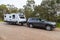 Bindoon, WA, Australia - Aug 22, 2020: A modern 4WD and caravan parked in a tree lined rest area next to a highway on a  cloudy