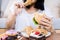 Binge eating disorder concept with woman eating fast food burger, fired chicken , donuts and desserts