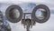 Binoculars Looking Over Snowy Swiss Mountains 