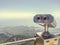 Binoculars on an observation deck made of gray metal. sightseeing tour, observing the view from the mountains. binoculars against