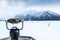 Binoculars overlooking Lake Minnewanka and cloud-covered Mount Inglismaldie in Banff