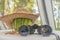 Binoculars and a striped watermelon in a straw hat on the table. Summer has come concept.Hot summer outdoor recreation