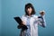 Biochemistry research specialist holding volumetric glass flask filled with blue unknown liquid substance sample.