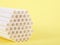 Biodegradable paper straws clustered together on yellow background