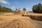 bioenergy plant, with rows of crops and biomass being harvested