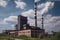 bioenergy plant with tall chimney and smoke, generating electricity