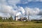 bioenergy plant, with visible smoke billowing from the chimneys