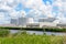 Biogas plant with large biomass digesters along a canal