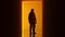 Biohazard Man in a Hazmat Suite in Silhouette Halloween Horror Shadow Simple Pumpkin Orange Corridor with a Polished Floor