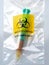 Biohazard specimen bag with a syringe and brown liquid