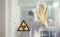 Biohazard symbol with unrecognizable doctor prohibiting passage