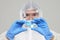 Biological hazard. Epidemic of the Chinese coronavirus. An asian woman in a protective suit and mask holds an injection syringe an