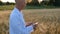 biologist agronomist, in a wheat field, at sunset, with a test tube in his hands