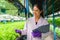 Biologist checking and recording growing of hydroponic vegetable