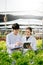 Biologist puts sprout in test tube for laboratory analyze. Two scientists stand in organic farm. check, laboratory in greenhouse