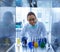 Biologist putting chemical bottles in incubator