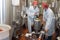 Biologist team talking and wearing hairnet in factory