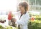 Biologist watering seedlings in greenhouse