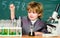 Biology school lab equipment. kid scientist studying science. Little boy at the elementary school. Little kid learning