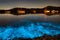 Bioluminescence glow in the bay nightscape with boats