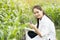 Biotechnology asian woman engineer examining plant leaf