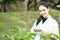 Biotechnology asian woman engineer examining plant leaf for disease, science and research concept