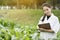 Biotechnology woman engineer examining plant leaf for disease