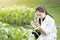 Biotechnology woman engineer examining plant leaf for disease