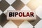 BIPOLAR word on wooden block on chess board. Mental health concept