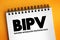 BIPV - Building-Integrated PhotoVoltaic acronym text on notepad, abbreviation concept background