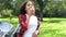 Biracial African American mixed race teenage girl young woman eating an apple by a tractor in an orchard