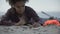 Biracial girl coughing lying on sand, refugee survived shipwreck, disaster