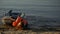 Biracial girl pulling boat, exhausted falling on sand, catastrophe survivor