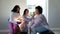 Biracial happy female friends applying make-up on young woman\'s face with afro hair at home