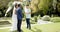 Biracial man officiating wedding ceremony for african american couple in garden, in slow motion