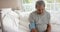Biracial senior man testing blood pressure in bed at home, slow motion