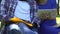 Biracial students working on university project, sitting on bench in park