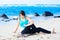 Biracial teen girl stretching and exercising on beach