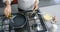 Biracial woman cooking and pouring oil on pan in kitchen, slow motion