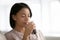 Biracial woman drink pure mineral water from glass