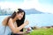 Biracial young woman eating shave ice, Diamond Head in backgrou