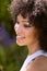 Biracial young woman smiling, standing outdoors at home