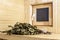 Birch besom lies on a wooden bench in the steam room, against the background of a window in a traditional Russian bath or Finnish