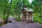 Birch booth shack and small bridge in the forest, Park Mon Repos, Vyborg, Russia