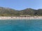 Birch, clear sea and mountains on the horizon. An ideal place for a seaside holiday. In the distance, a Mediterranean beach, view