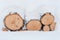 Birch lumps are under the snow. Firewood under the snow