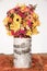 Birch tree trunk with autumnal flower ball, decoration for thanksgiving