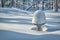 Bird bath covered with snow in winter sunshine in Minnesota