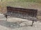 Bird droppings on wooden bench in the park. Splatters of bird feces on wooden bench in the park.